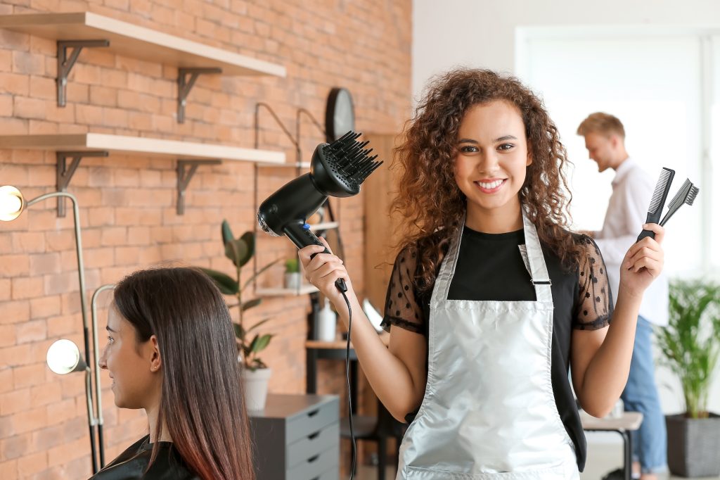 young african american hairdresser in beauty salon