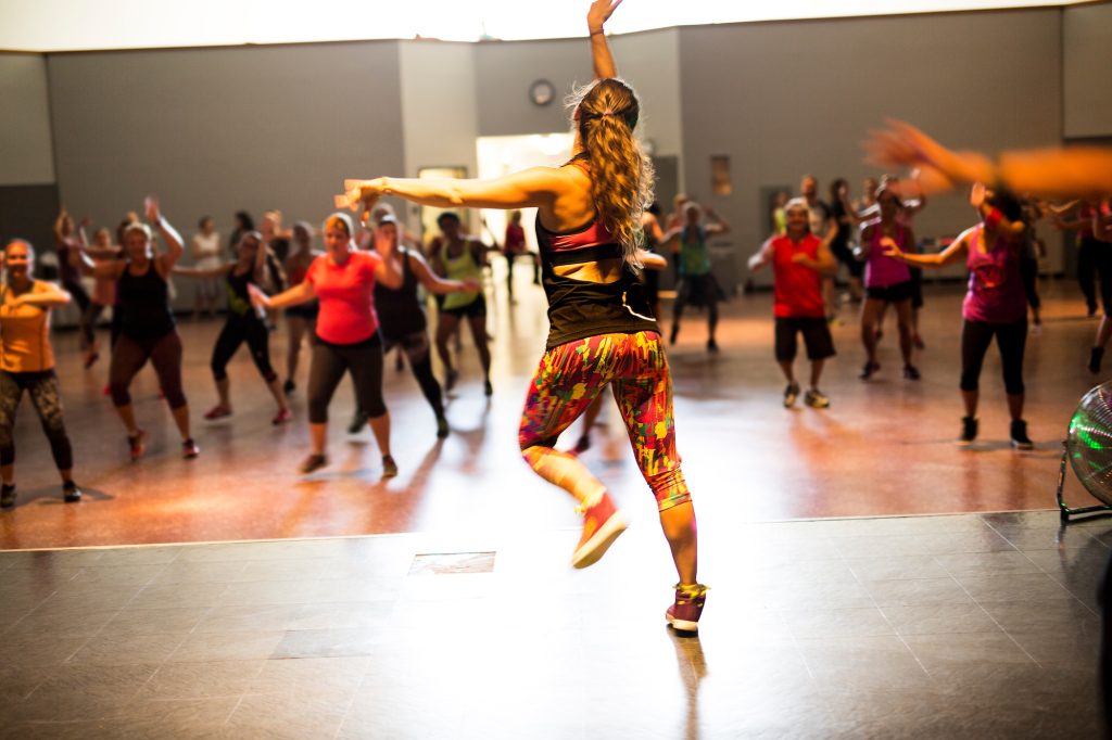 a group of young people working out in a fitness gym